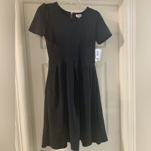 Lularoe Amelia dress, NWT. Solid black with rose gold zipper detail. Size small